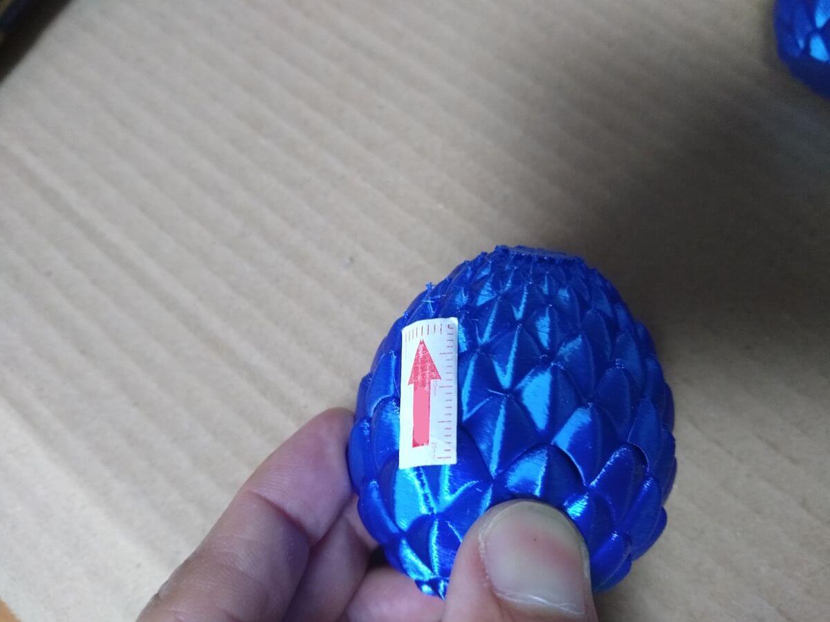 Sharp burrs visible from another angle on 3D printed dragon egg