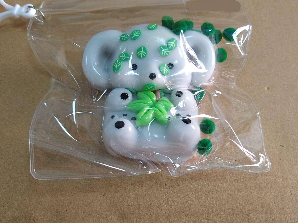 PVC pouch packaging - direct contact between sticky TPR koala and dyed plastic leaves