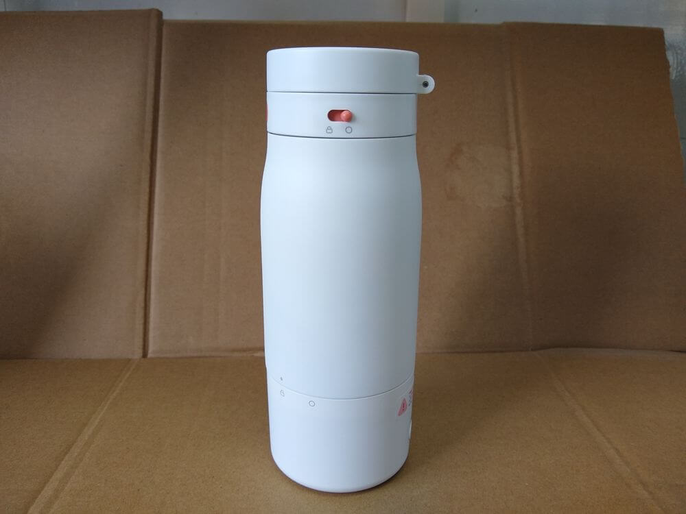 Stainless steel electronic milk warmer bottle — overall front view, white body with electronic base