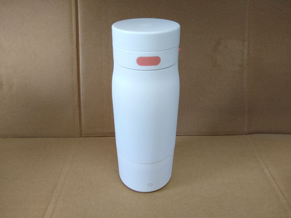 Electronic milk warmer — front view showing the stainless steel bottle and electronic base alignment