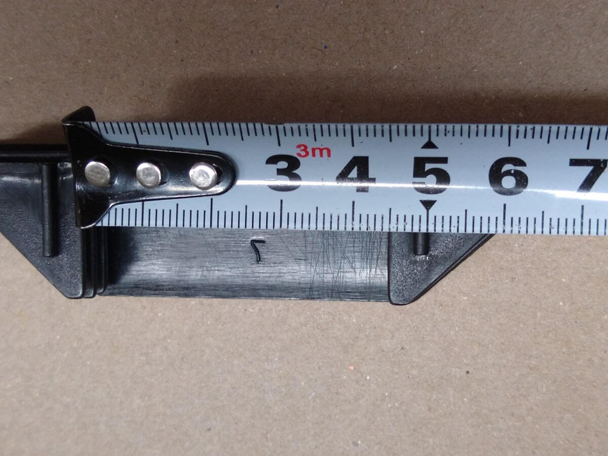 Plastic seal cap spacing measured at 4.5 cm — 2 mm short of the frame hole spacing