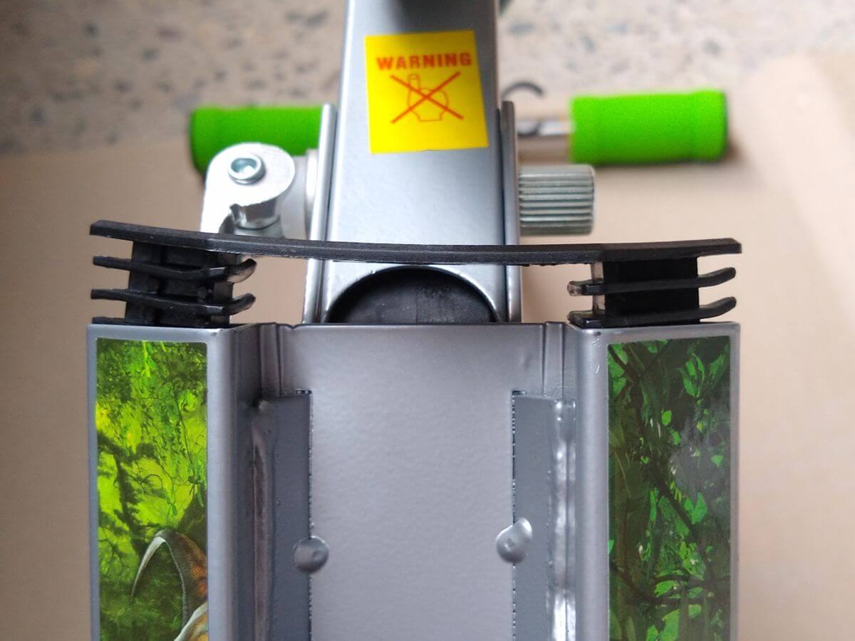 Both ends of the plastic seal cap pressed in together — the cap buckles and lifts