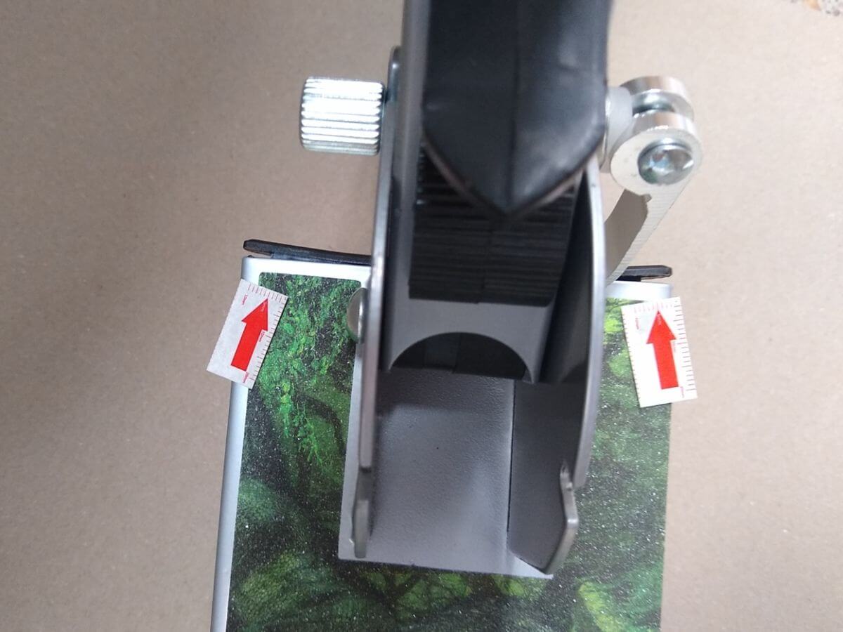 Lifted plastic seal cap leaving a visible gap along both edges of the scooter frame