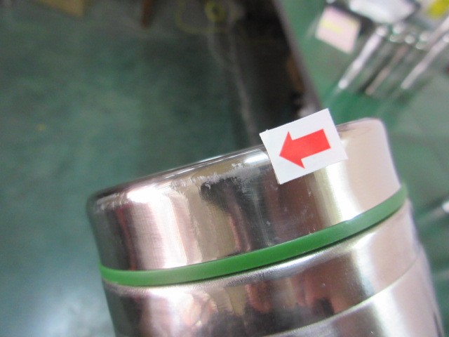 Close-up showing poor polishing surface defect on stainless steel bottle