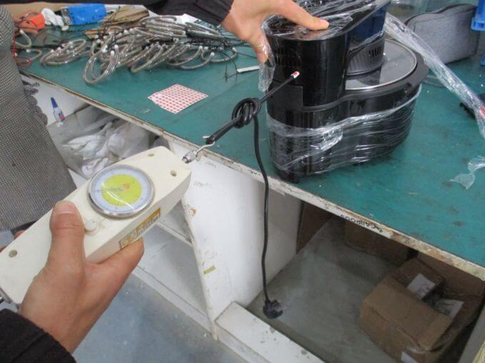 Electrical inspection in China: cord anchorage pull test with marked displacement