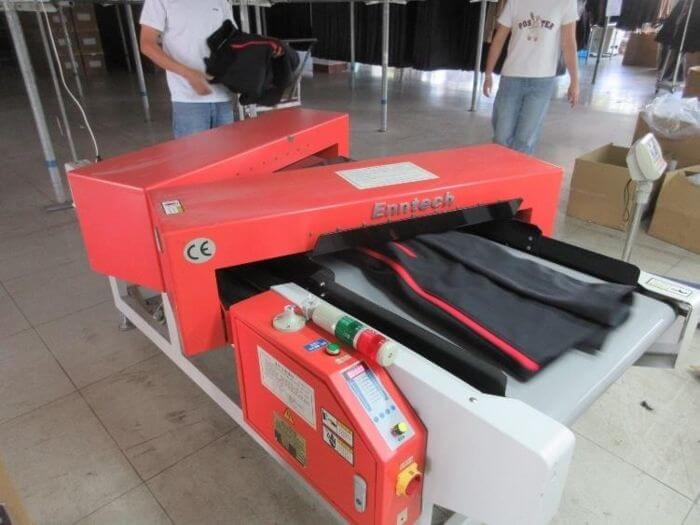 Apparel inspection in China: garment passing through a needle detector