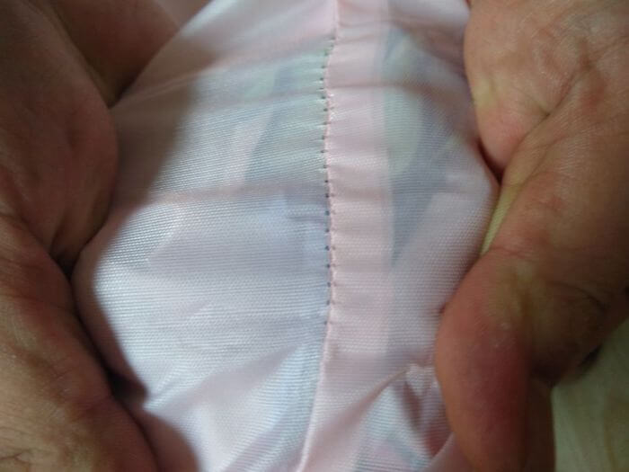 Apparel inspection in China: seam pull test on a garment at a high-stress point