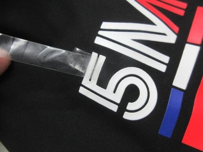 Apparel inspection in China: 3M 810 tape adhesion test on a garment print
