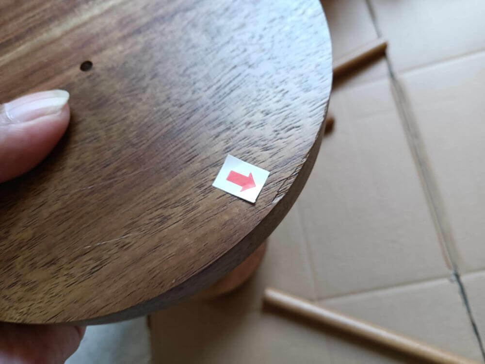 Close-up of base panel edge chipping — cosmetic defect that would trigger Amazon returns on premium products