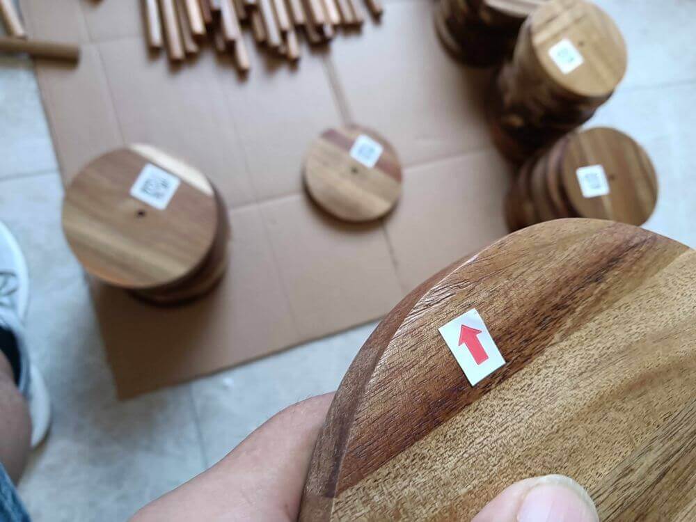 Multiple edge chipping defects across sampled acacia wood base panels