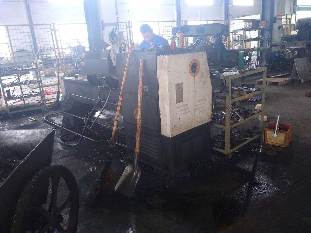 Worker operating production equipment during factory audit