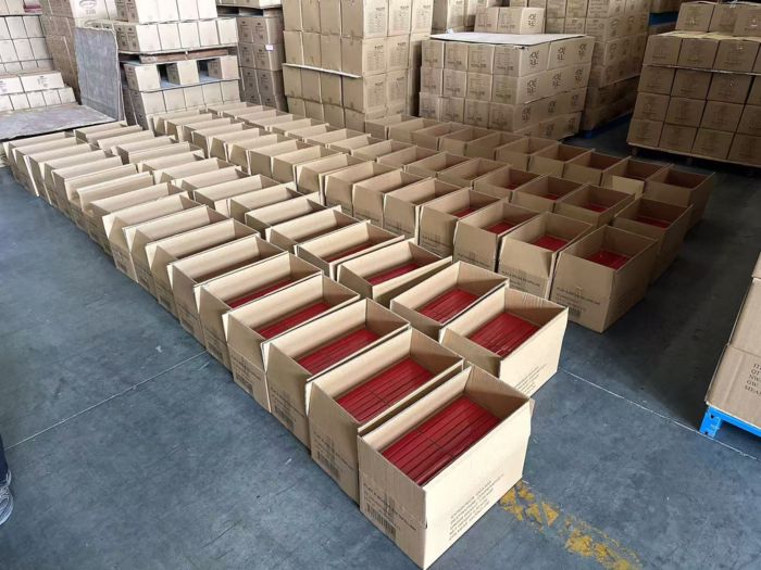 Opened outer cartons staged at a full inspection sorting station in China