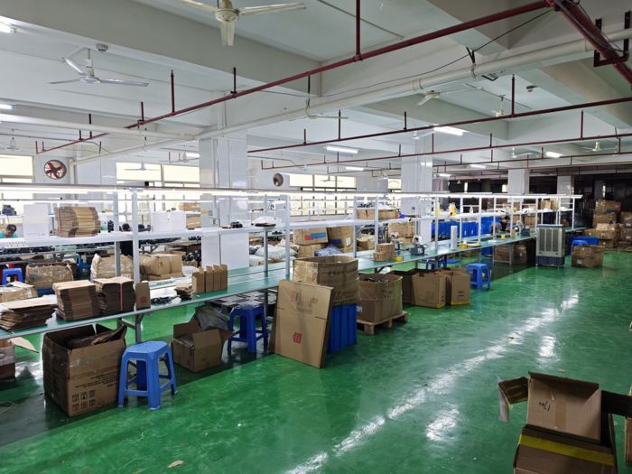 Inspector checking units on the packaging line during a 100% full inspection