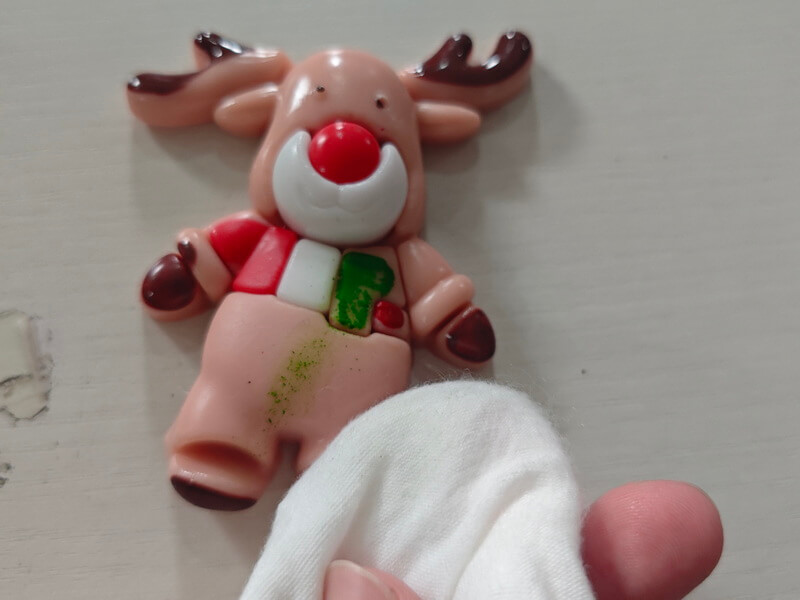 Initial Production Check result: close-up of paint adhesion failure on TPR deer squishy toy, substandard PVC ink used instead of TPR-specific flexible ink